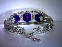 Natural Amethyst bracelet two 8mm rounds and one 10 mm round 6.7ctw.