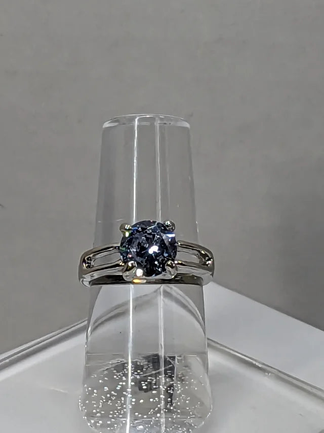 Aquamarine cubic zirconia ring on ring holder 