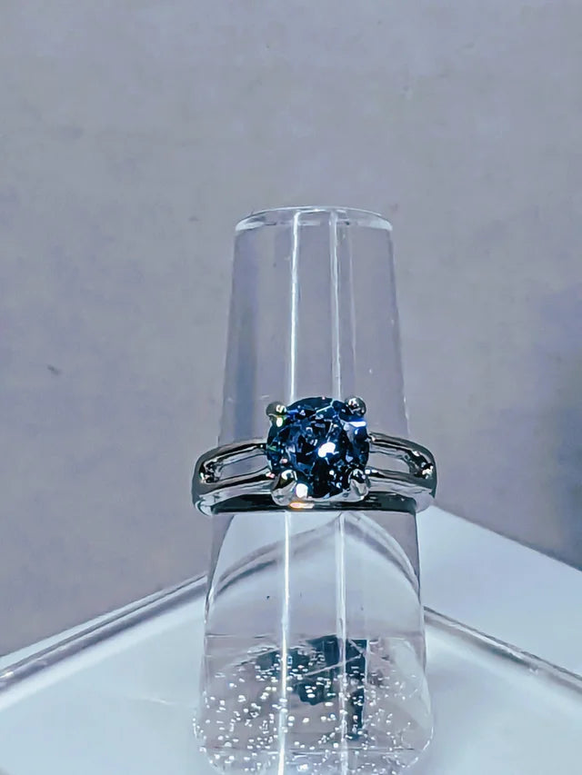 Aquamarine cubic zirconia ring on ring holder